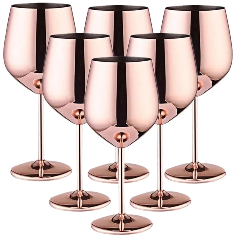 Set of six rose gold wine glasses on a white background
